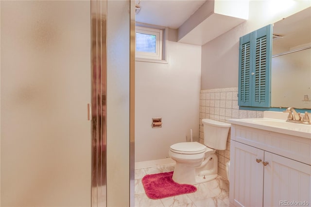 815 Hoyt St, Lakewood, CO 80215 - bathroom with vanity, a stall shower, tile walls, and a wainscoted wall