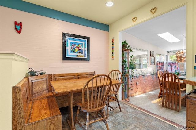 dining room with a skylight and recessed lighting