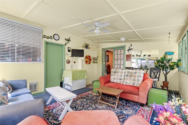 living room featuring ceiling fan and baseboards