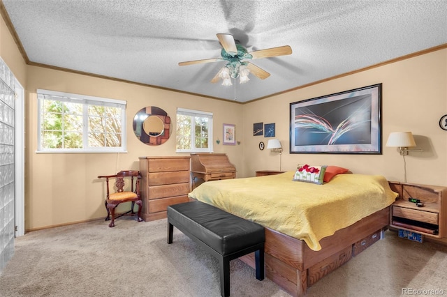 bedroom featuring ornamental molding, carpet flooring, a textured ceiling, ceiling fan, and baseboards