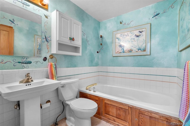 bathroom with toilet, a garden tub, tile walls, and tile patterned flooring