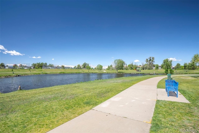 view of property's community featuring a water view and a lawn