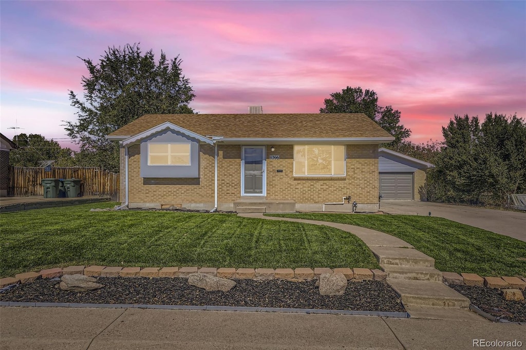 view of front of house with a yard and a garage