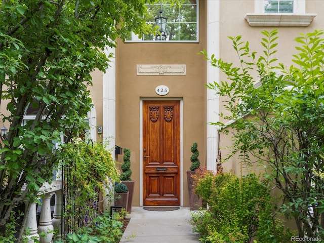 425 Steele St, Denver, CO 80206 - doorway to property featuring stucco siding