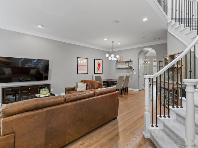 425 Steele St, Denver, CO 80206 - living area with stairs, arched walkways, light wood-type flooring, recessed lighting, and crown molding