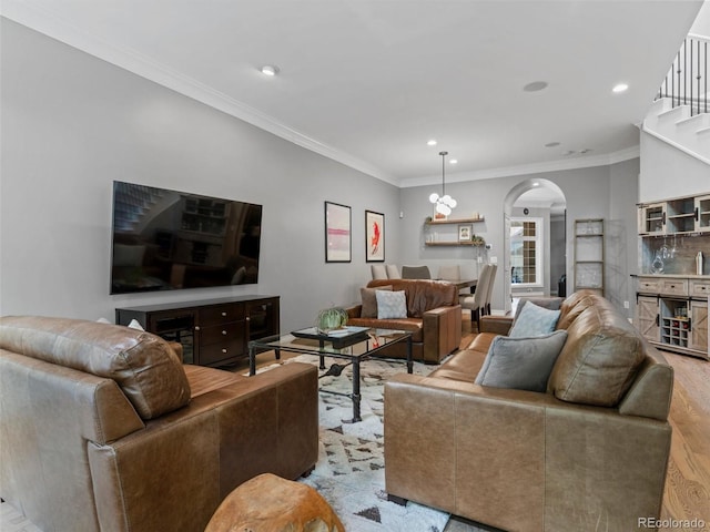 425 Steele St, Denver, CO 80206 - living room with arched walkways, wood finished floors, recessed lighting, and ornamental molding