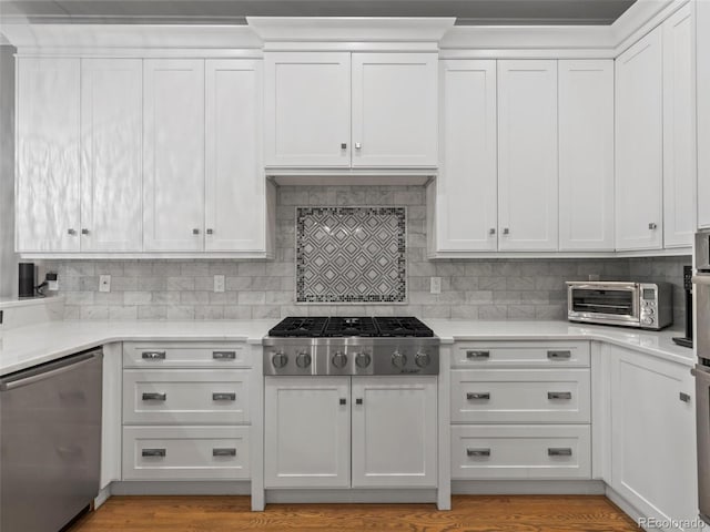 425 Steele St, Denver, CO 80206 - kitchen with stainless steel appliances, white cabinetry, light countertops, and tasteful backsplash