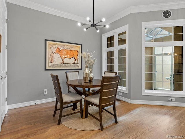 425 Steele St, Denver, CO 80206 - dining room featuring crown molding, a chandelier, light wood-style flooring, and plenty of natural light