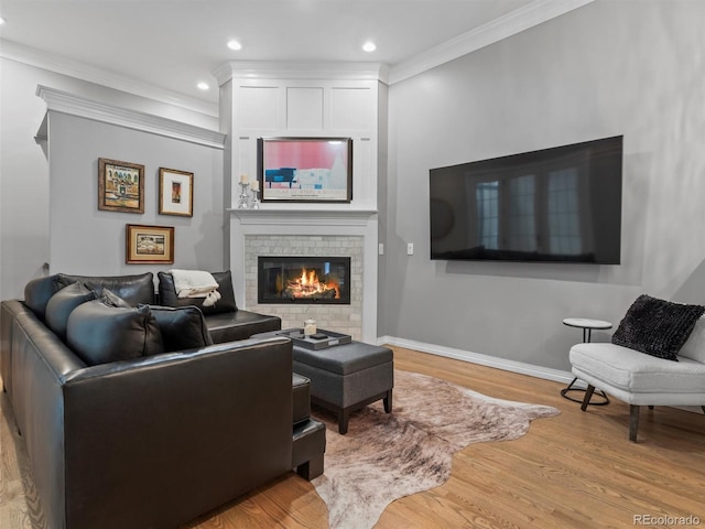 425 Steele St, Denver, CO 80206 - living area with wood finished floors, a brick fireplace, ornamental molding, and recessed lighting