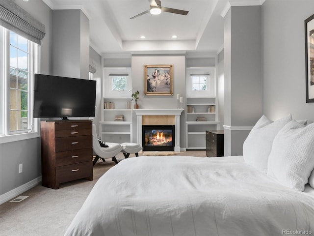 425 Steele St, Denver, CO 80206 - bedroom with multiple windows, a glass covered fireplace, light carpet, recessed lighting, and crown molding