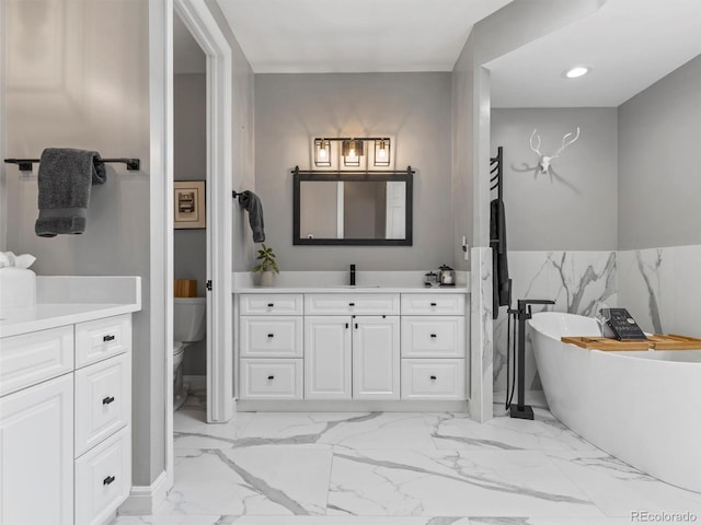 425 Steele St, Denver, CO 80206 - bathroom with vanity, marble finish flooring, a freestanding bath, tile walls, and recessed lighting