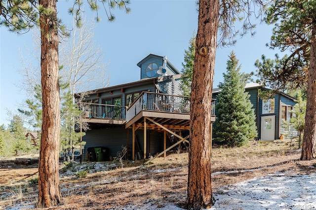 rear view of property with a wooden deck