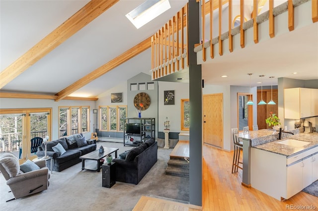 living room featuring high vaulted ceiling, recessed lighting, a baseboard radiator, beamed ceiling, and light wood-style floors