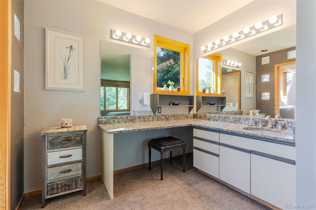 bathroom featuring baseboards and vanity