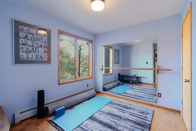 exercise area featuring baseboards, baseboard heating, and a baseboard heating unit