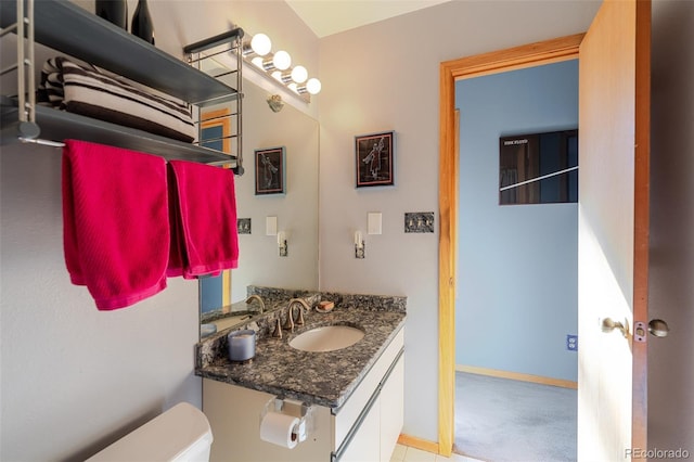 bathroom featuring toilet and vanity