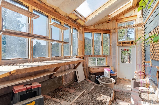sunroom / solarium featuring high vaulted ceiling