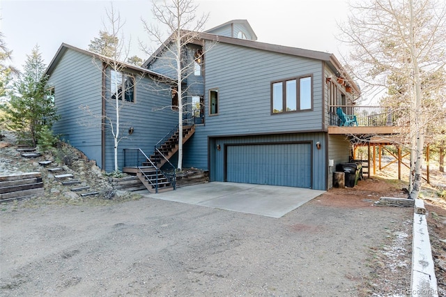 exterior space with driveway, stairway, and an attached garage