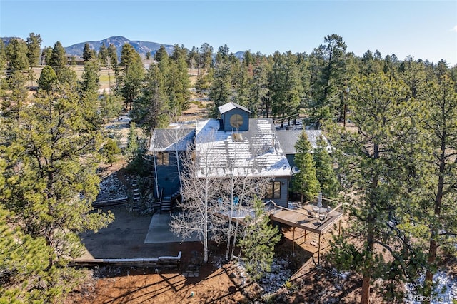 bird's eye view featuring a forest view and a mountain view