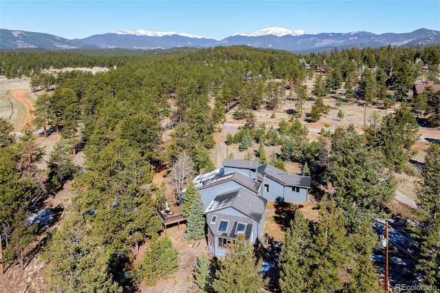 bird's eye view with a mountain view and a forest view