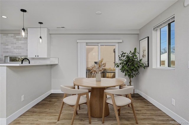 dining area featuring hardwood / wood-style floors and sink