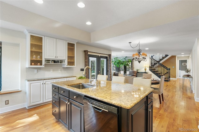 kitchen featuring sink, white cabinetry, dishwasher, and a kitchen island with sink