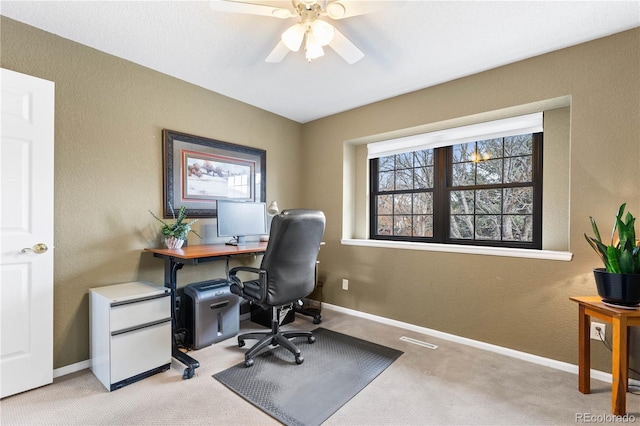 office with ceiling fan and light carpet