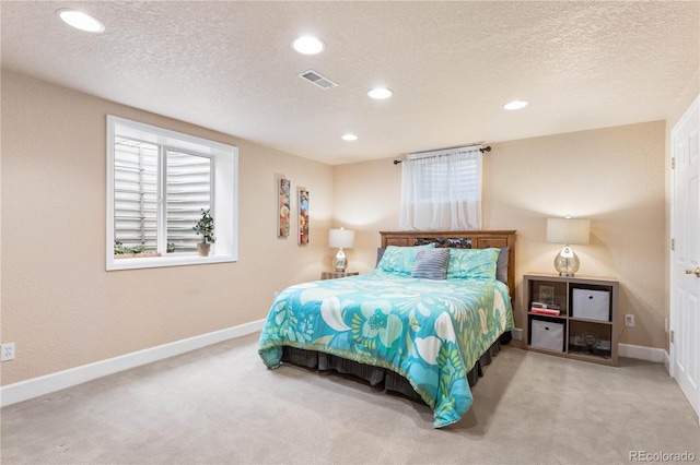 bedroom with a textured ceiling and carpet flooring