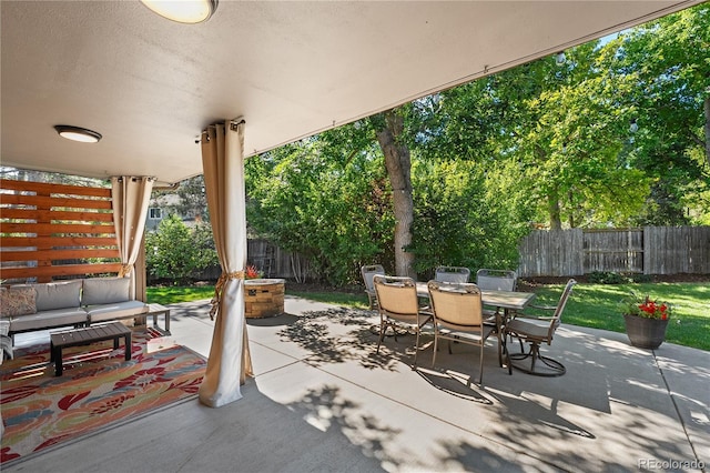 view of patio / terrace featuring an outdoor living space with a fire pit