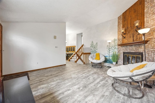 living room with wood-type flooring and a brick fireplace