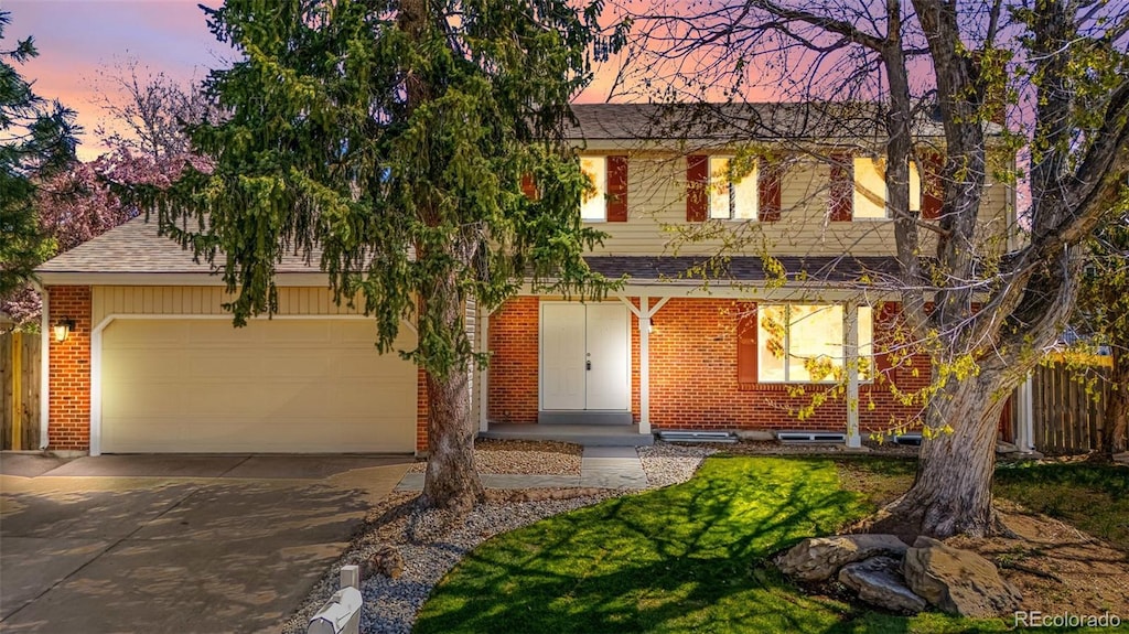 5556 S Sedalia St, Centennial, CO 80015 - traditional-style house featuring brick siding, an attached garage, concrete driveway, and fence
