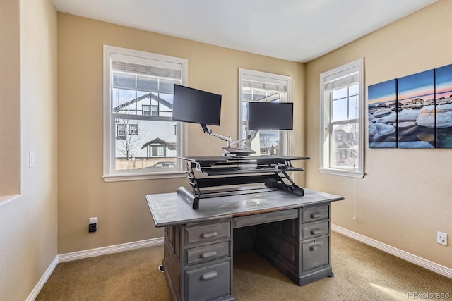 carpeted office space featuring baseboards