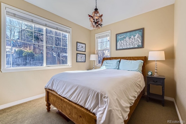 bedroom featuring carpet and baseboards