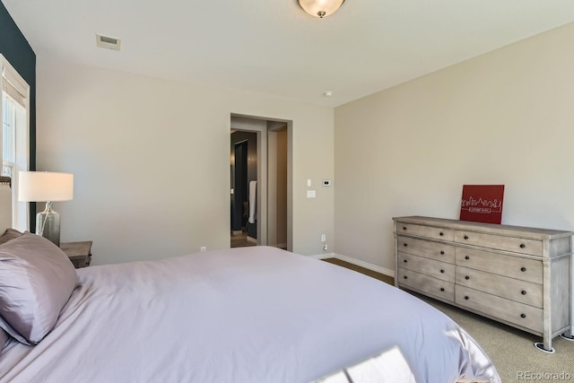 carpeted bedroom with baseboards and visible vents