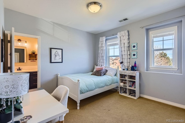 bedroom featuring carpet, ensuite bath, visible vents, and baseboards