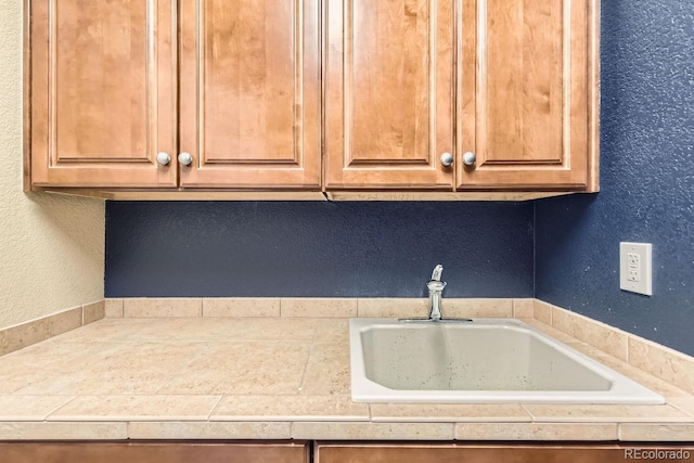 kitchen with a sink and a textured wall