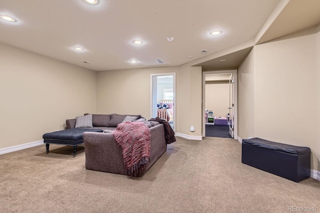 carpeted living area featuring recessed lighting, visible vents, and baseboards