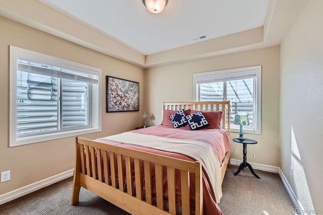 carpeted bedroom with visible vents and baseboards