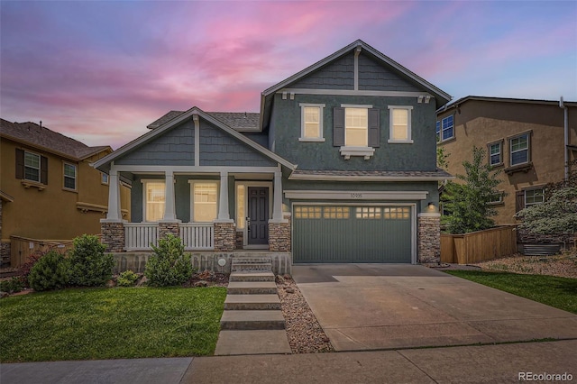 10935 Valleybrook Cir, Highlands Ranch, CO 80130 - craftsman house featuring covered porch, driveway, stone siding, a yard, and a garage