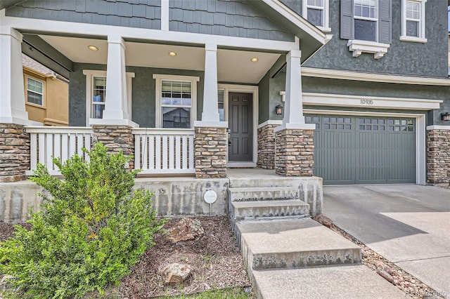 10935 Valleybrook Cir, Highlands Ranch, CO 80130 - view of exterior entry with a garage, stone siding, stucco siding, and a porch