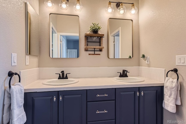 10935 Valleybrook Cir, Highlands Ranch, CO 80130 - bathroom featuring double vanity and a textured wall
