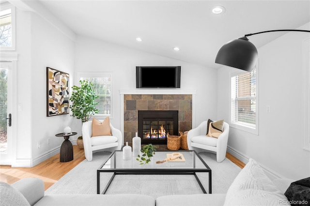 living area with vaulted ceiling, a fireplace, wood finished floors, and recessed lighting