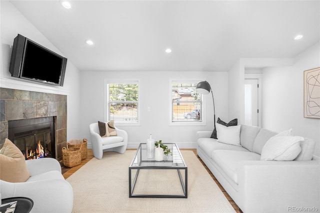 living area featuring wood finished floors, a tile fireplace, and recessed lighting