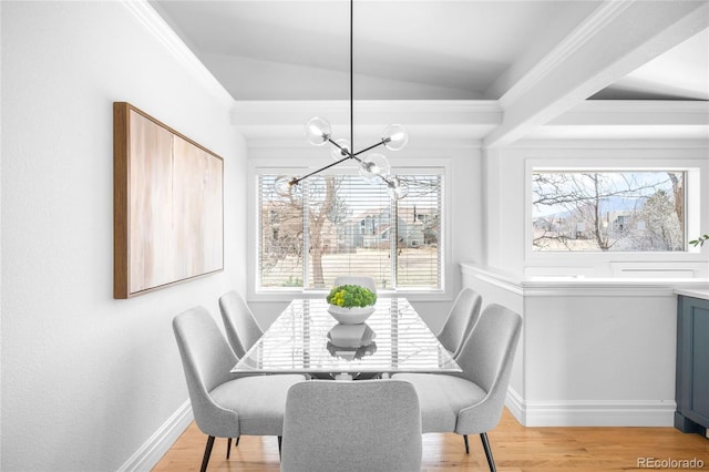 dining room with light wood-style flooring, vaulted ceiling, baseboards, and a chandelier