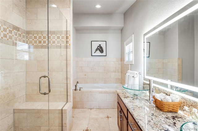 full bath featuring tile patterned flooring, a shower stall, vanity, and a bath