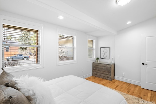 bedroom featuring recessed lighting, baseboards, beamed ceiling, and light wood finished floors