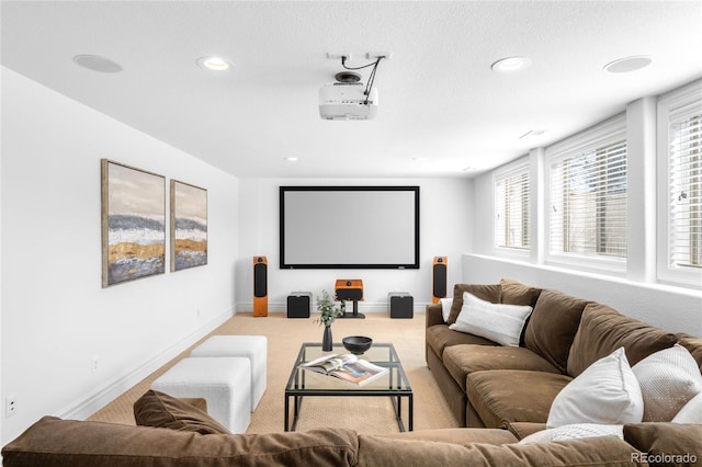 carpeted home theater room with recessed lighting and baseboards