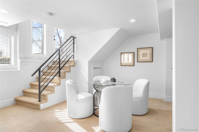 dining area with carpet, stairway, and baseboards