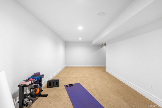 exercise area featuring recessed lighting, light colored carpet, and baseboards