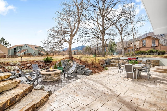 view of patio featuring a fire pit and outdoor dining space